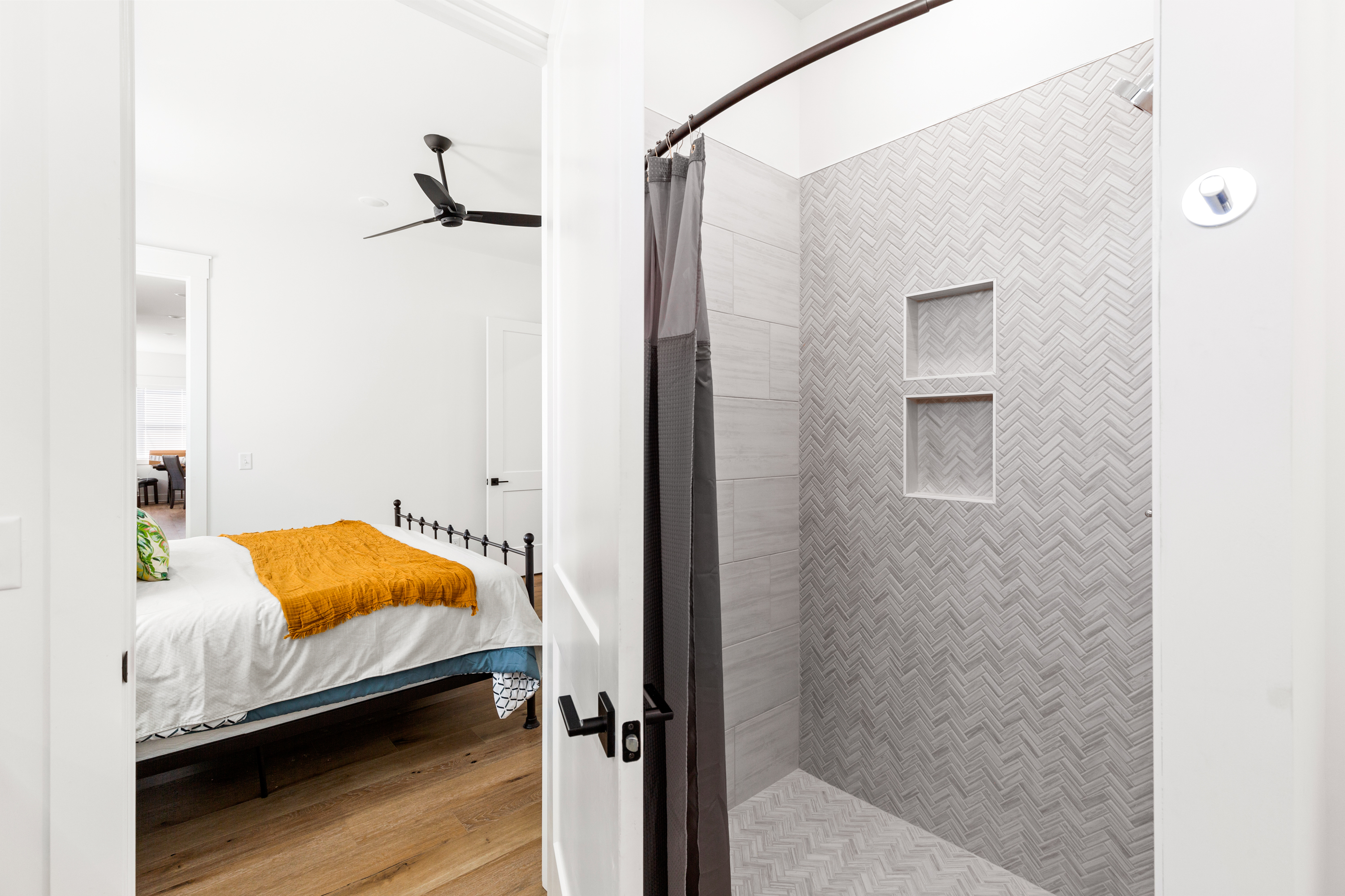 Walk-in shower with herringbone tile and built-in shelving